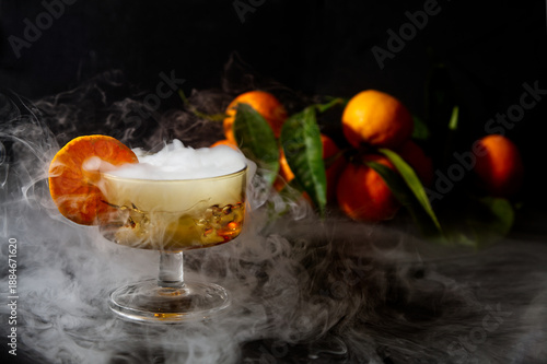 Creamy Orange Dessert in Glass with Dry Ice Smoke and Fresh Oranges in Background
