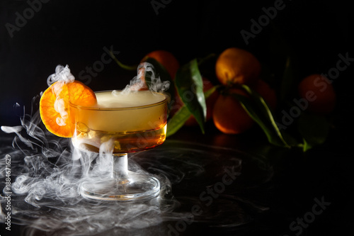 Creamy Orange Dessert in Glass with Dry Ice Smoke and Fresh Oranges in Background