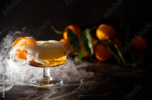 Elegant Cocktail With Orange Slice Garnish And Dramatic fresh misty effect In A Glassware Setting and Fresh Oranges in Background