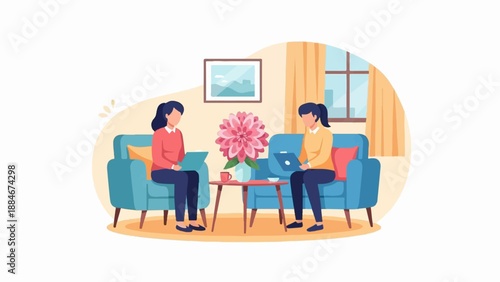 Two women working on laptops while sitting on sofas in a room