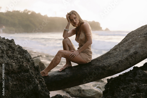 Wallpaper Mural Blonde woman posing between coastal rocks on beach Torontodigital.ca