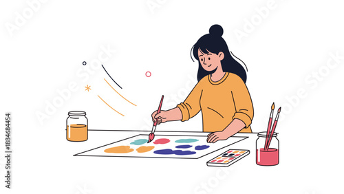Young asian female artist painting with brushes and watercolors
