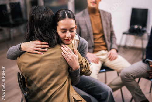 People hugging each other during a group therapy session, expressing emotional support, empathy, trust, and connection in a safe mental health environment.