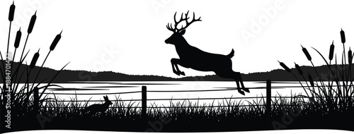 Silhouette of a deer leaping over a fence near a lake with reeds and a rabbit in the foreground