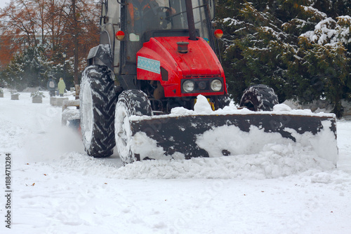 Canvas Print Red Tractor Plowing Snow in Winter Landscape