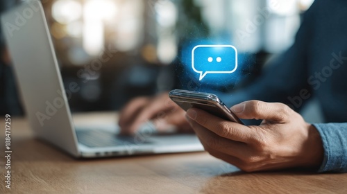 Person using smartphone and laptop computer to send and receive messages online