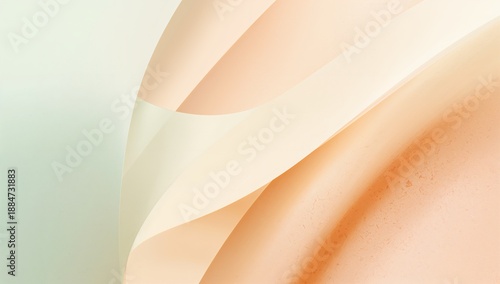A close-up view of a delicate peach-colored fabric with smooth folds and gentle curves