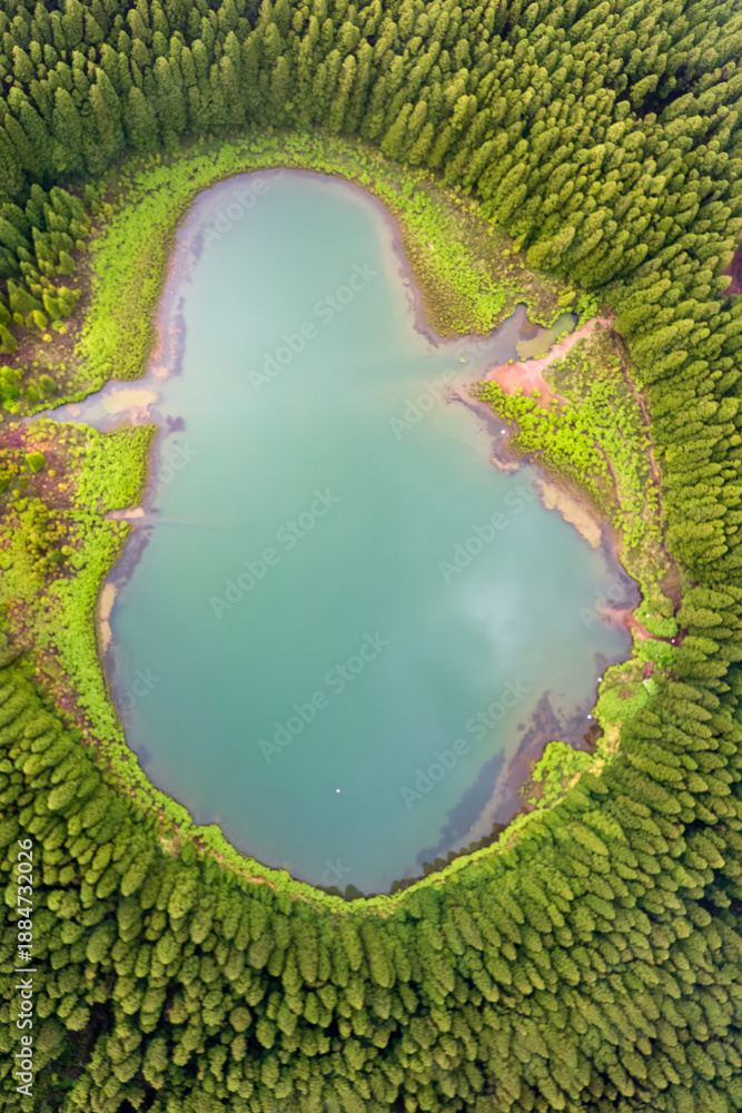 Obraz premium Drone view of Canario Lagoon. Lake formed by the crater of an old volcano in San Miguel island, Azores, Portugal. Scenic landscape. Ghost shape aerial illusion.