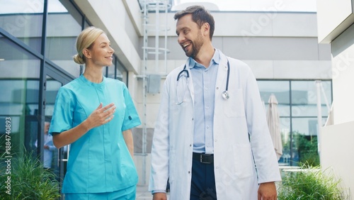 Wallpaper Mural Smiling female nurse walking beside focused male doctor outside clinic. Confident pair discussing duties while moving along pathway. Professional team sharing thoughts during relaxed moment. Torontodigital.ca