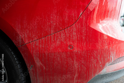 Close up of dirty red car body panel texture.