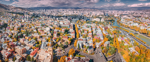 Bilde på lerret Aerial view over Tbilisi cityscape, showing the Mtkvari river winding through th