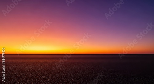 Vast empty dark asphalt floor or ground surface meeting a brilliant orange and purple sunset sky on the dramatic horizon line, surface, dramatic, street