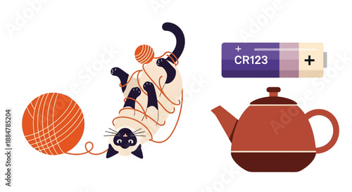 Cats playing with yarn ball and teapot with battery CR123 nearby for power