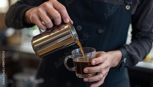 Barista Pours Coffee Into Cup at Cafe During Morning Hours on a Busy Day