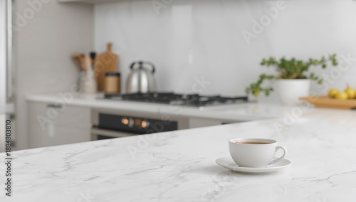 Coffee Cup on Marble Counter in Modern Kitchen With Kettle and Stove During D...