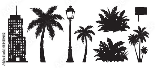 Set of black grunge urban silhouettes featuring a skyscraper, tropical palm trees, a vintage lamppost, and exotic foliage, presented as a graphic vector design element collection
