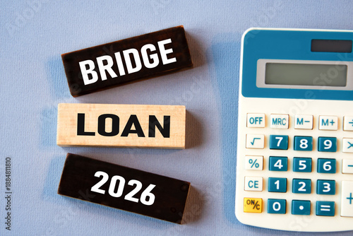 BRIDGE LOAN 2026 - words on wooden colored blocks against a calculator background