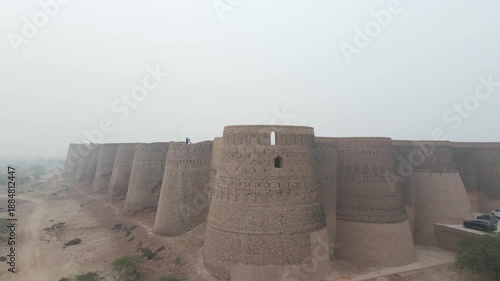 A cinematic shot of a rising drone before the iconic and corner bastion of Derawar Fort. This fort is on the tentative list of UNESCO World Heritage Site.
