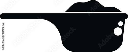 Scoop containing washing powder for laundry use, illustrating measurement