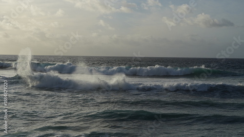 Spectacular sunset contemplating the force of the sea crashing agains the cliff