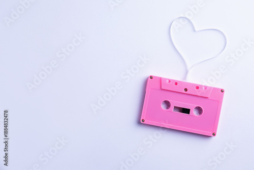 Music cassette and heart made with tape on white background, top view. Space for text