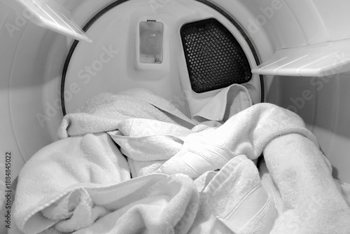 Load of clean towels inside a tumble dryer drum