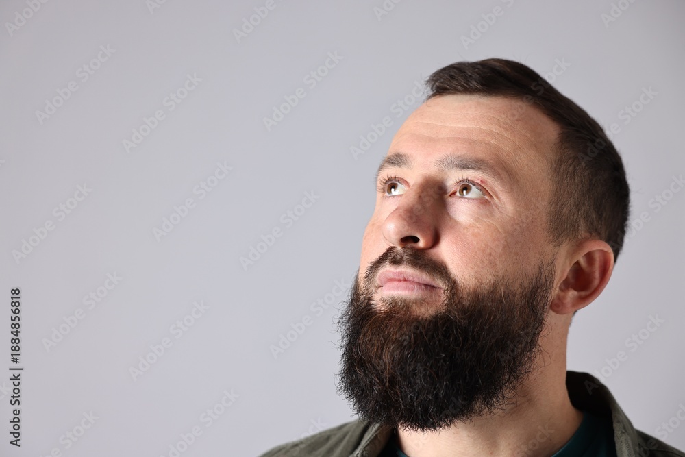 Obraz premium Man with mustache and beard on light grey background. Space for text