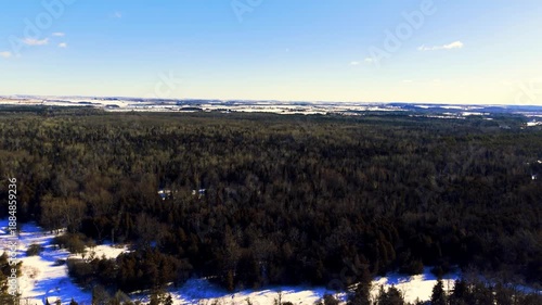drone flying over snow covered forest