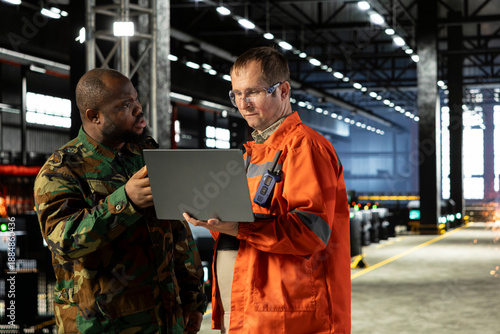 Konstfotografi Military officer and plant supervisor manages wartime production in the factory, machinery and equipment support strategic defense operation