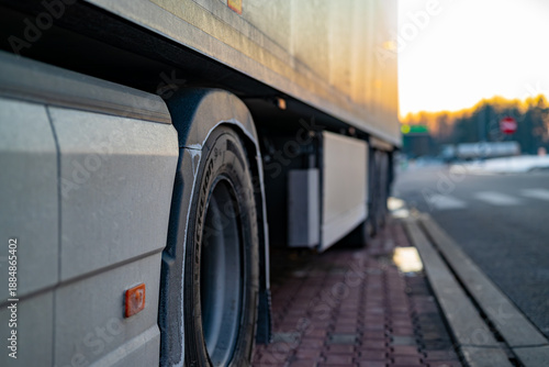 Details of truck chassis and wheel arch, professional commercial vehicle at a rest area.