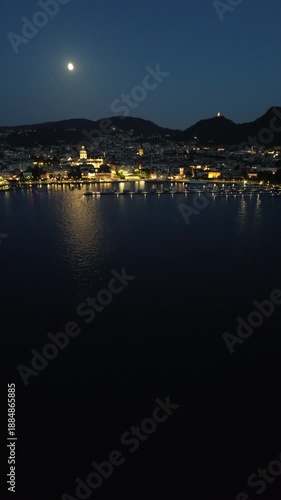 Cinematic drone footage of Como Lake at night with moonlight and city lights reflecting on the mirror-like water in vertical format for social media 3