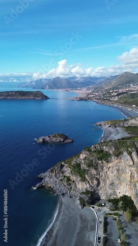 Spectacular vertical drone footage of Dino Island near Praia a Mare Calabria showcasing the coast and the contrast between the blue sea and green mountains 2