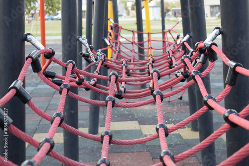 Playground rope net structure perspective view. Rope net playground structure for climbing and balance activities in city park. Children play equipment photographed without people.