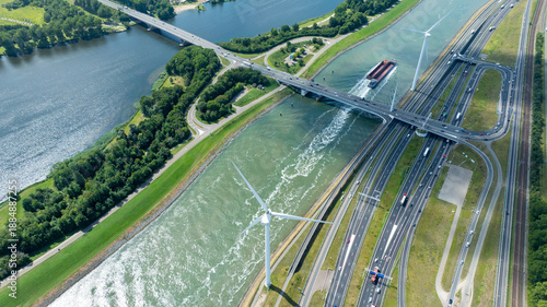 Photography Aerial View of Inland Shipping Canal with Wind Turbines and Highway Bridge in Po