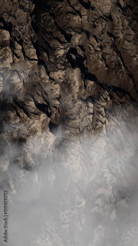 Vertical cinematic mountain background with passing clouds and slow aerial motion, natural animation based on Nasa imagery
