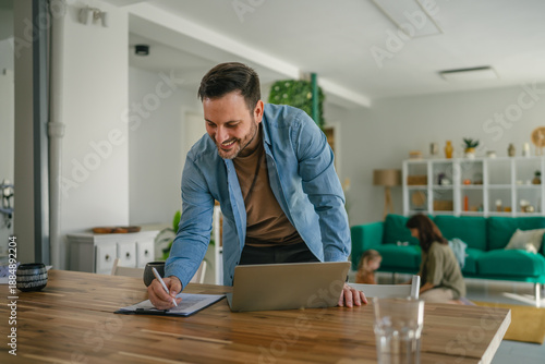 Obraz na plátně Father working from home balancing profession and family life