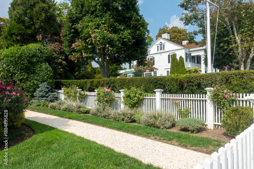 Nicely landscaped home  in Southport, Connecticut with white picket fence. 