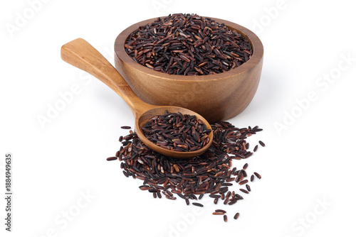 Riceberry rice in a wooden spoon and a wooden cup, with some spilled on the floor. isolated on white background.