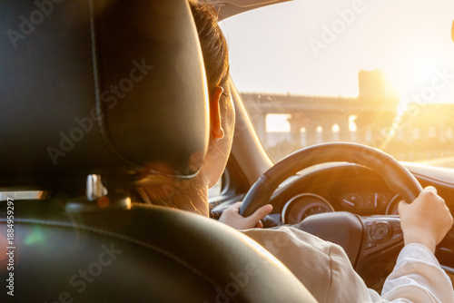 Female driver driving a car from the rear seat perspective