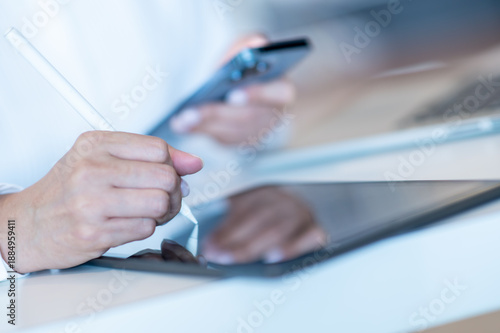 business woman working on smartphone labtop and pointing pen on talbet