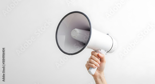 Person Holding a White Megaphone Against a Light Gray Background