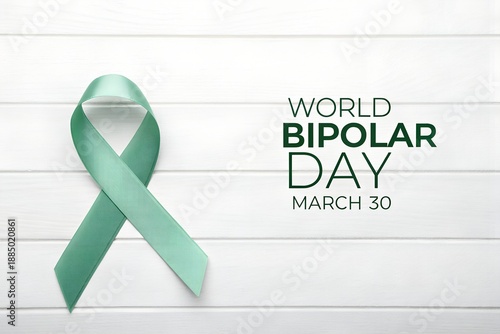 Awareness ribbon representing world bipolar day on march thirtieth displayed against a clean white wooden background promoting mental health support and understanding globally