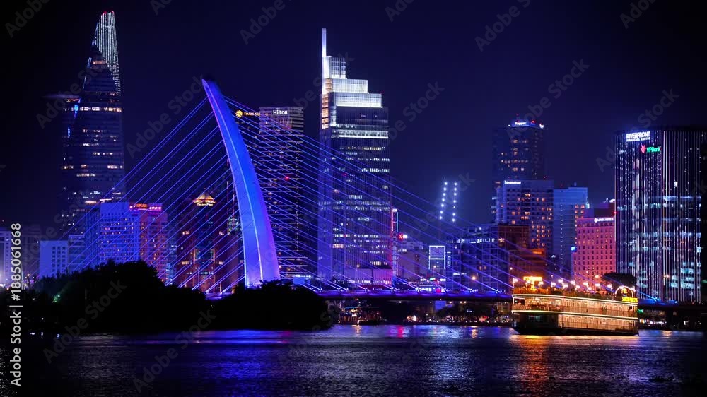 custom made wallpaper toronto digitalNight view of Bitexco Tower, colorful buildings, Bason bridge and Saigon river in Ho Chi Minh city, tourist boats and cruises on Saigon river