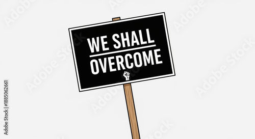 Black protest sign with 'we shall overcome' slogan on wooden stick symbolizing hope and resilience