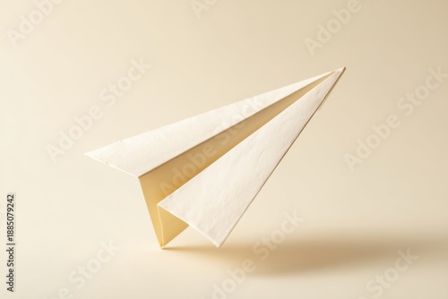 Wallpaper Mural Off white paper airplane on uniform beige background. Simple symbol of travel, communication, freedom, vision, idea, concept. Torontodigital.ca