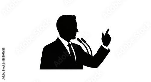 Businessman giving a speech in silhouette pointing while standing at a podium with two microphones in a formal setting
