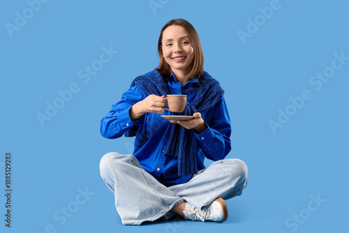 Young woman with cup of tea...