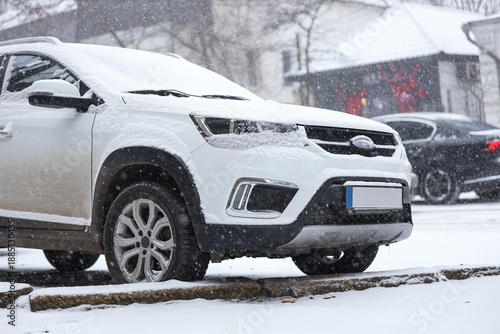White car covered with snow...