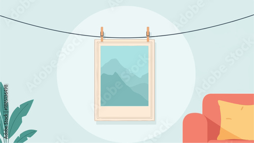 A framed landscape image hangs on a wall above a couch and plant