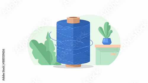 A blue spool of thread sits on a table with plants